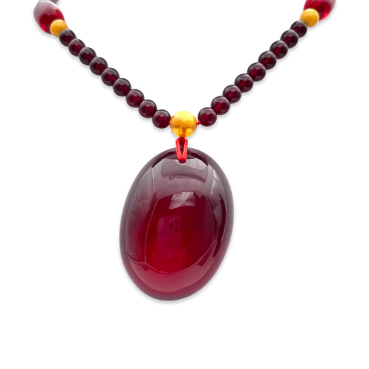 Red amber pendant with lens