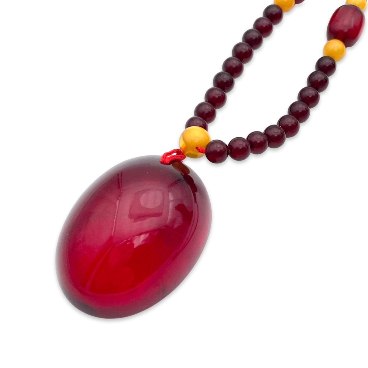 Red amber pendant with lens